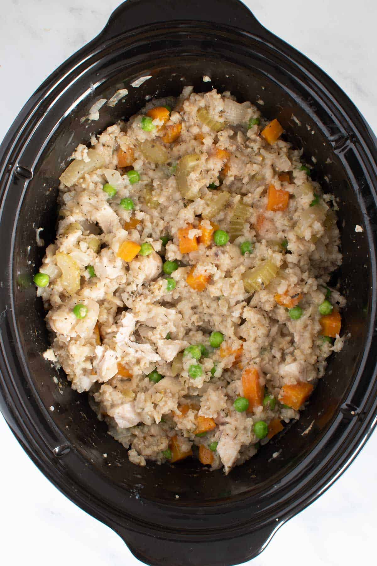 Chicken, rice and vegetables in a crockpot.