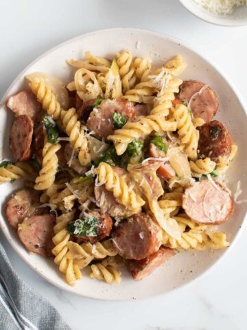 Pasta with kielbasa sausage on a plate.