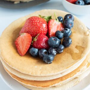 Oat milk pancakes with blueberries and strawberries.
