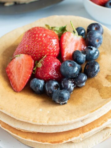 Oat milk pancakes with blueberries and strawberries.