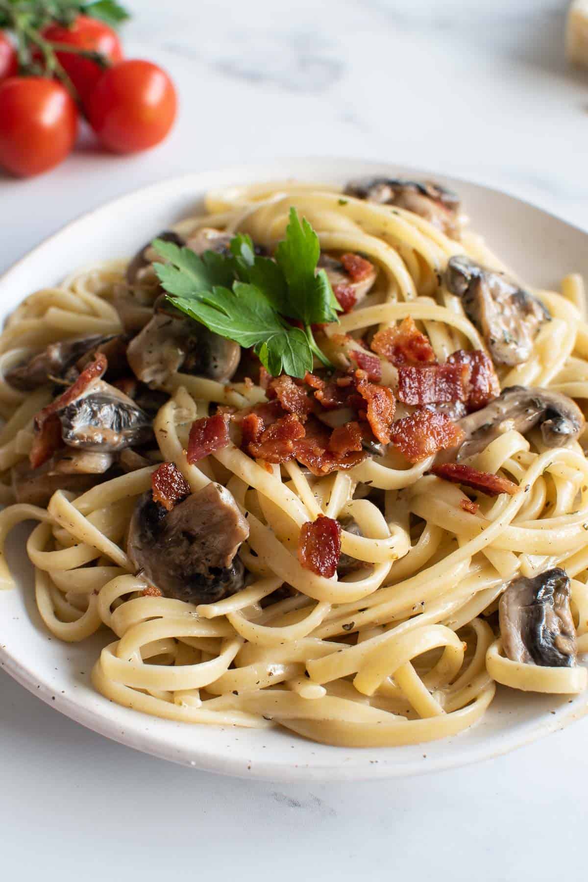 Linguine in a creamy sauce with bacon and mushrooms.