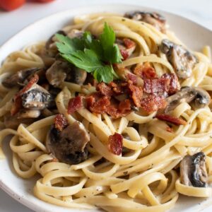 Close up of bacon and mushroom pasta.