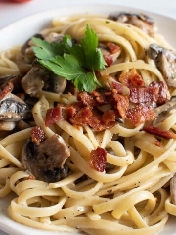 Close up of bacon and mushroom pasta.