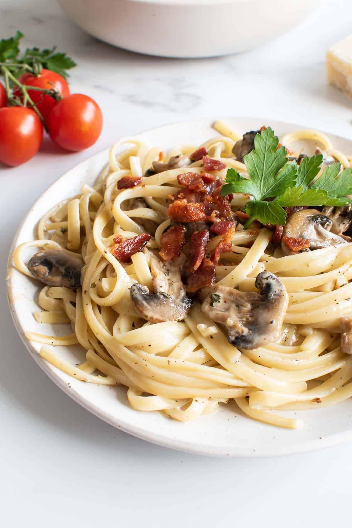 Mushroom and bacon pasta on a plate.