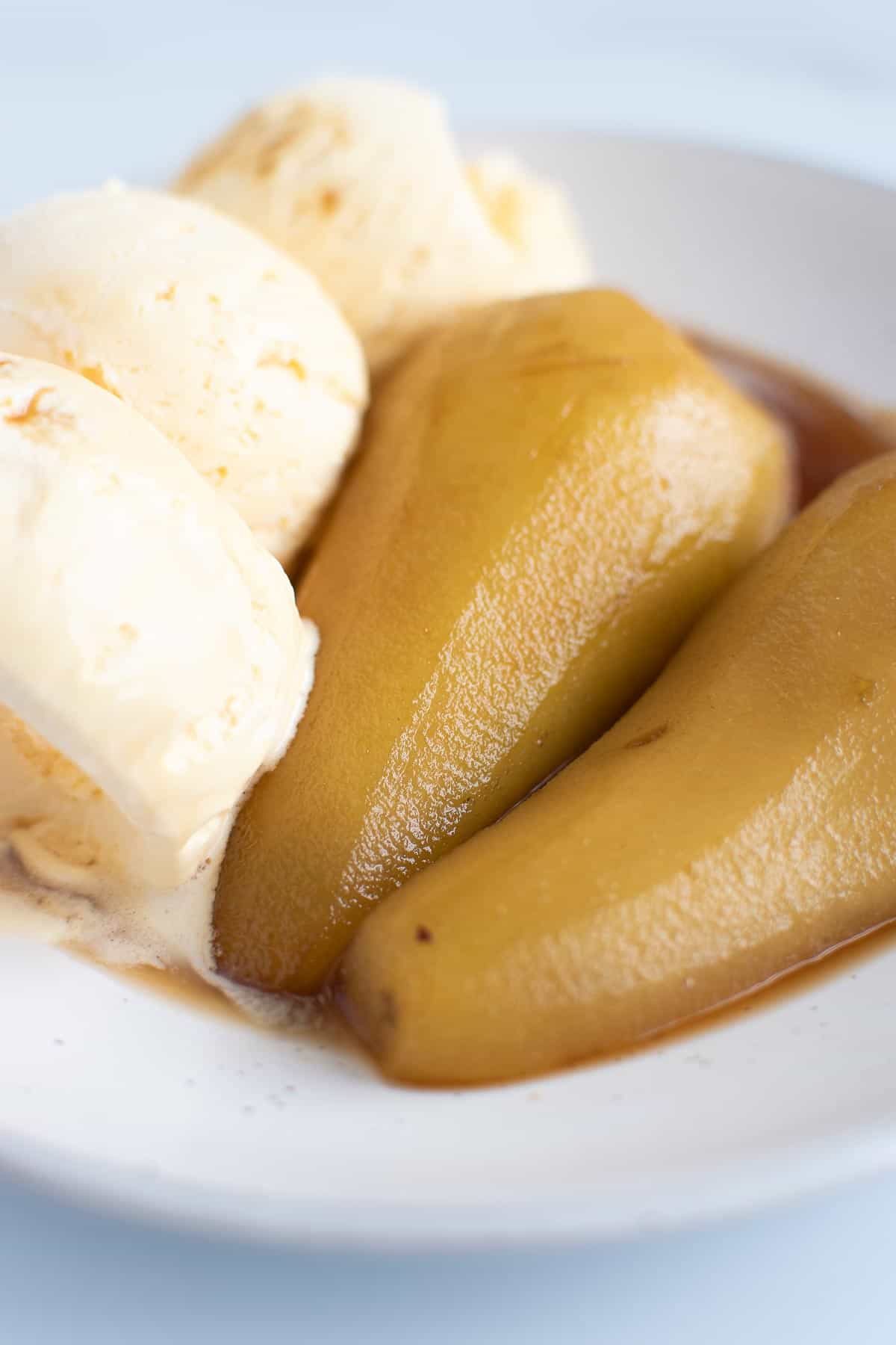 Close up of pears with brandy sauce and ice cream.