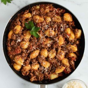 Gnocchi bolognese in a skillet.