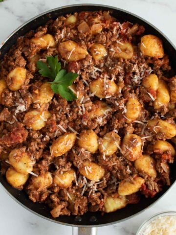 Gnocchi bolognese in a skillet.