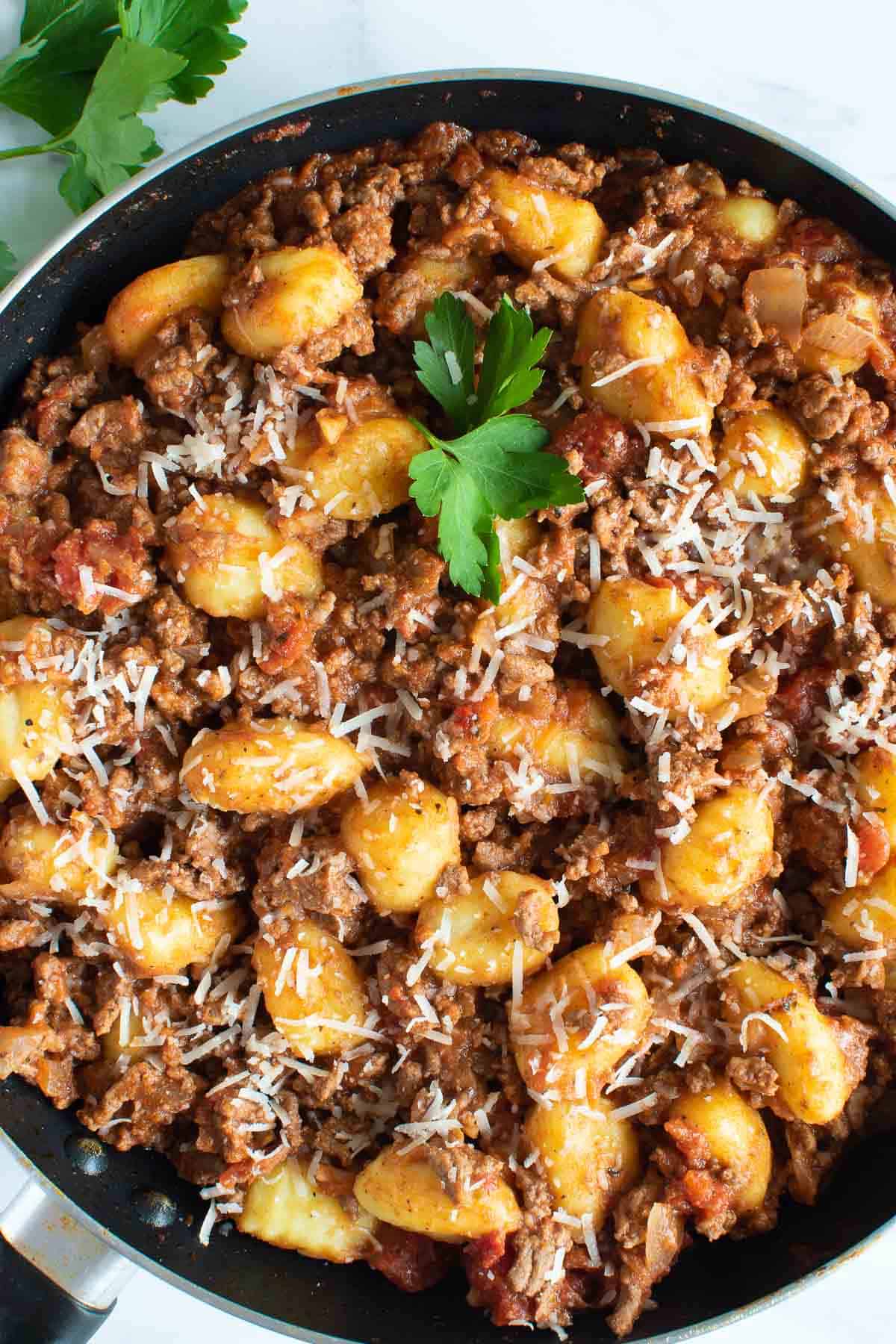 Close up of gnocchi with bolognese sauce.