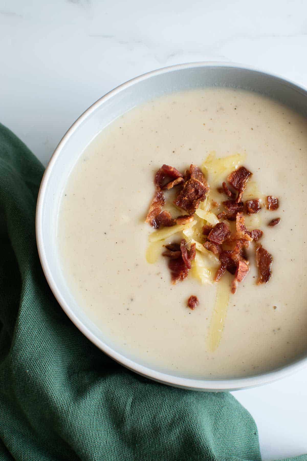 Creamy cauliflower soup with bacon bits.