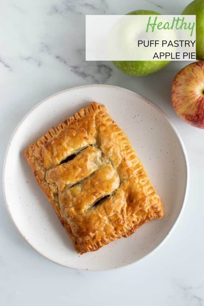 Puff pastry apple hand pie on a plate.