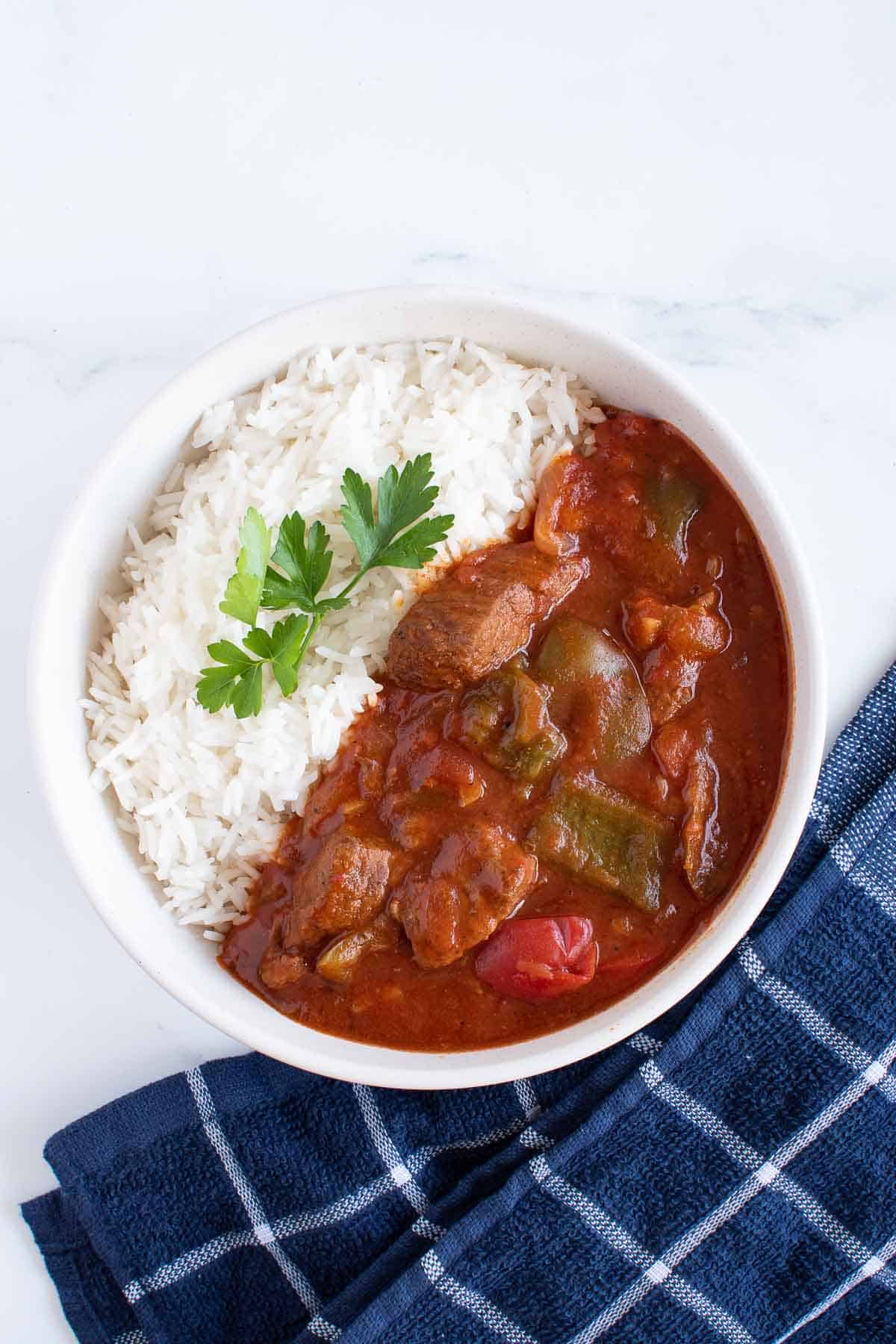 A bowl of crockpot goulash and rice.