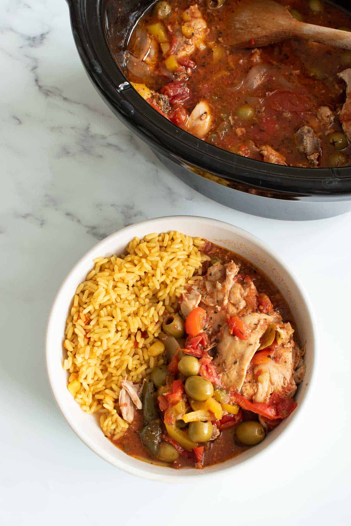 Chicken, olive and pepper stew with rice on the side.