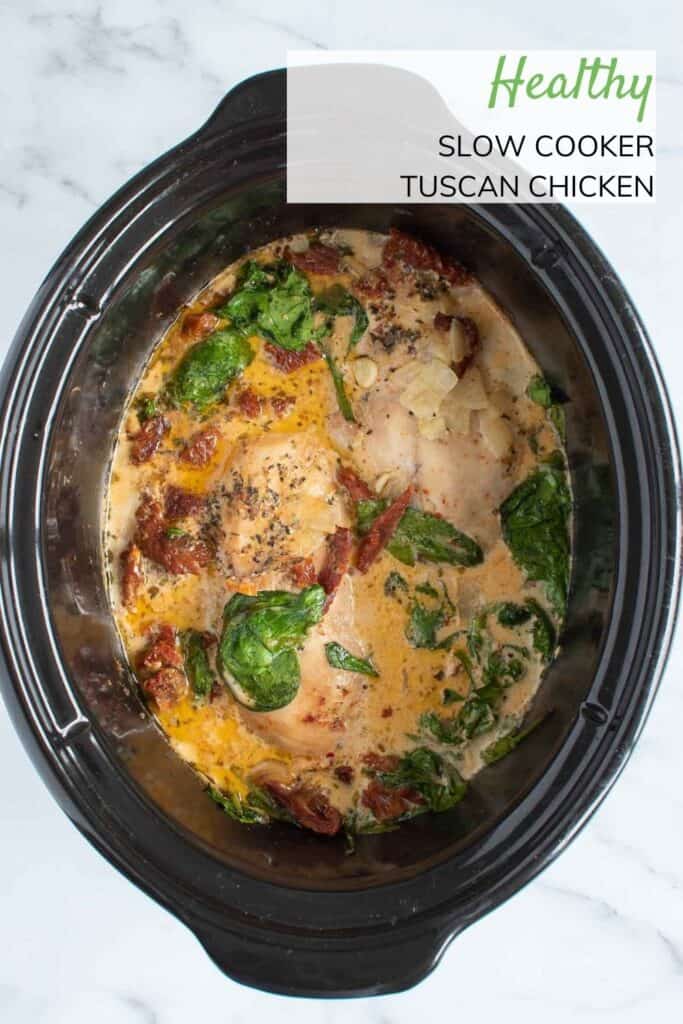 Creamy Tuscan chicken in a slow cooker.