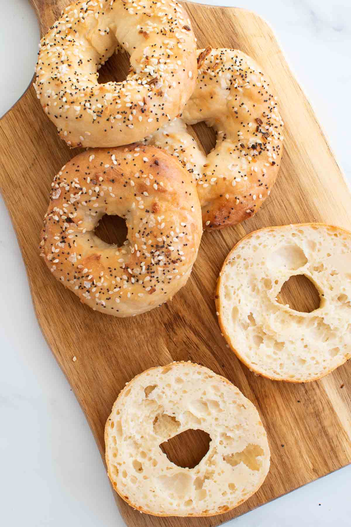 Homemade bagels on a cutting board.