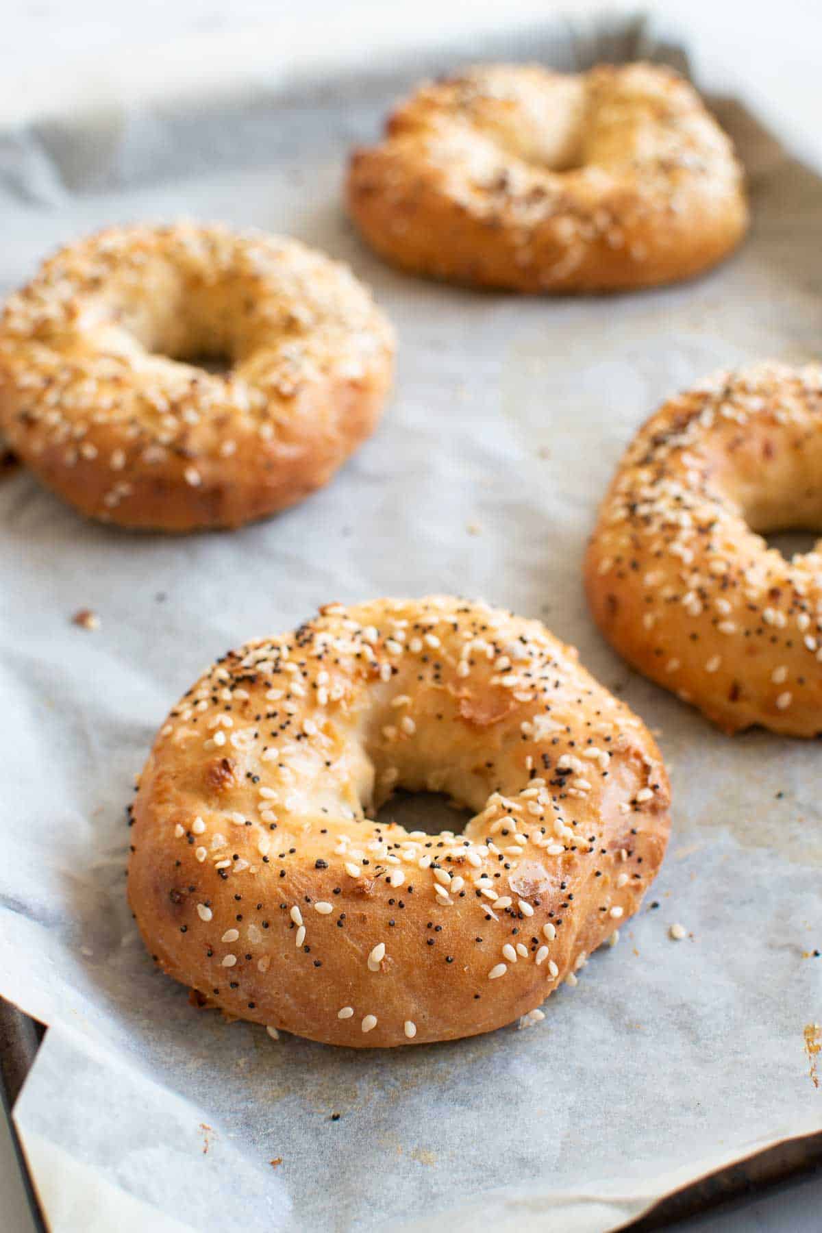 Four homemase bagels with everything seasoning.