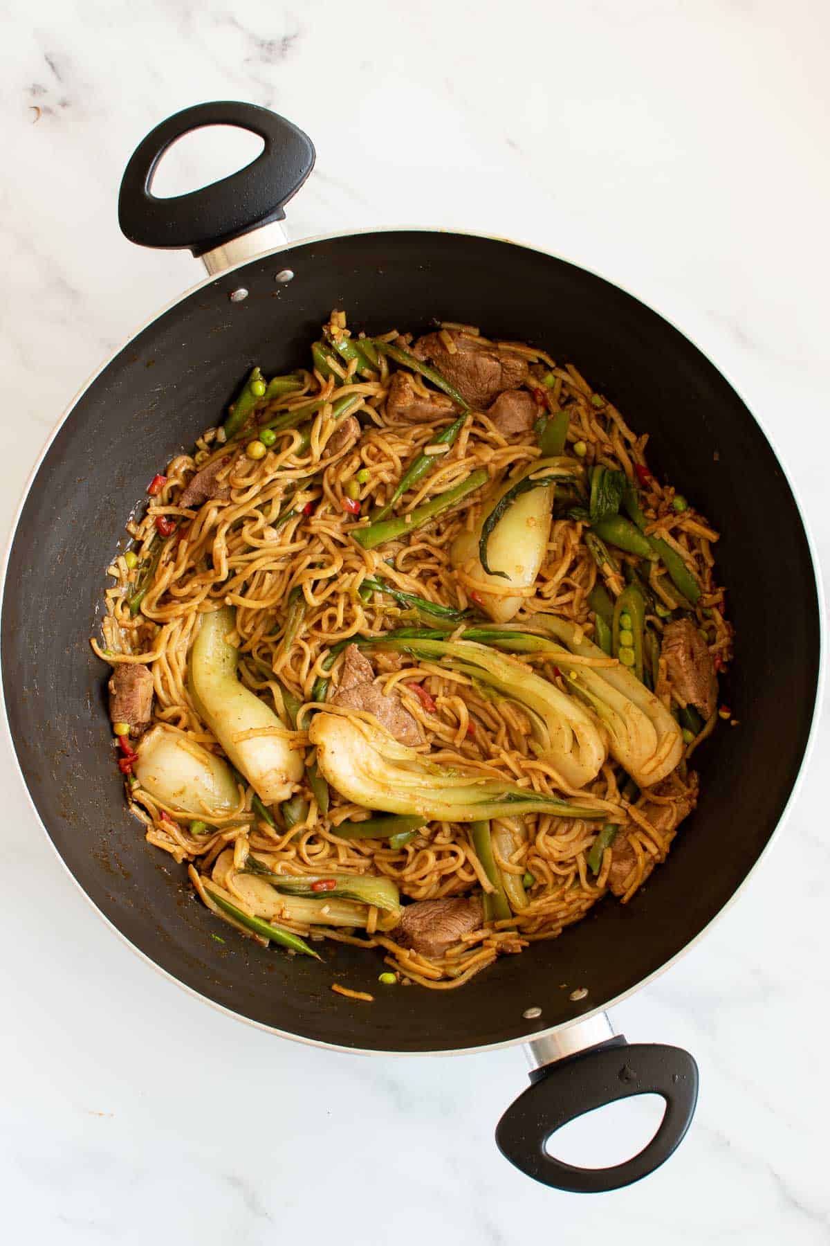 Duck stir fry with bok choi in a wok.