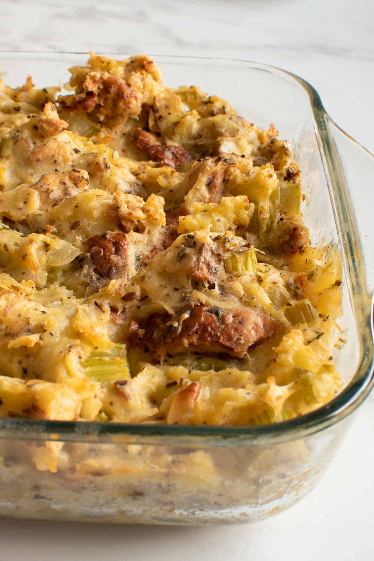 Bread and potato stuffing in a casserole dish.