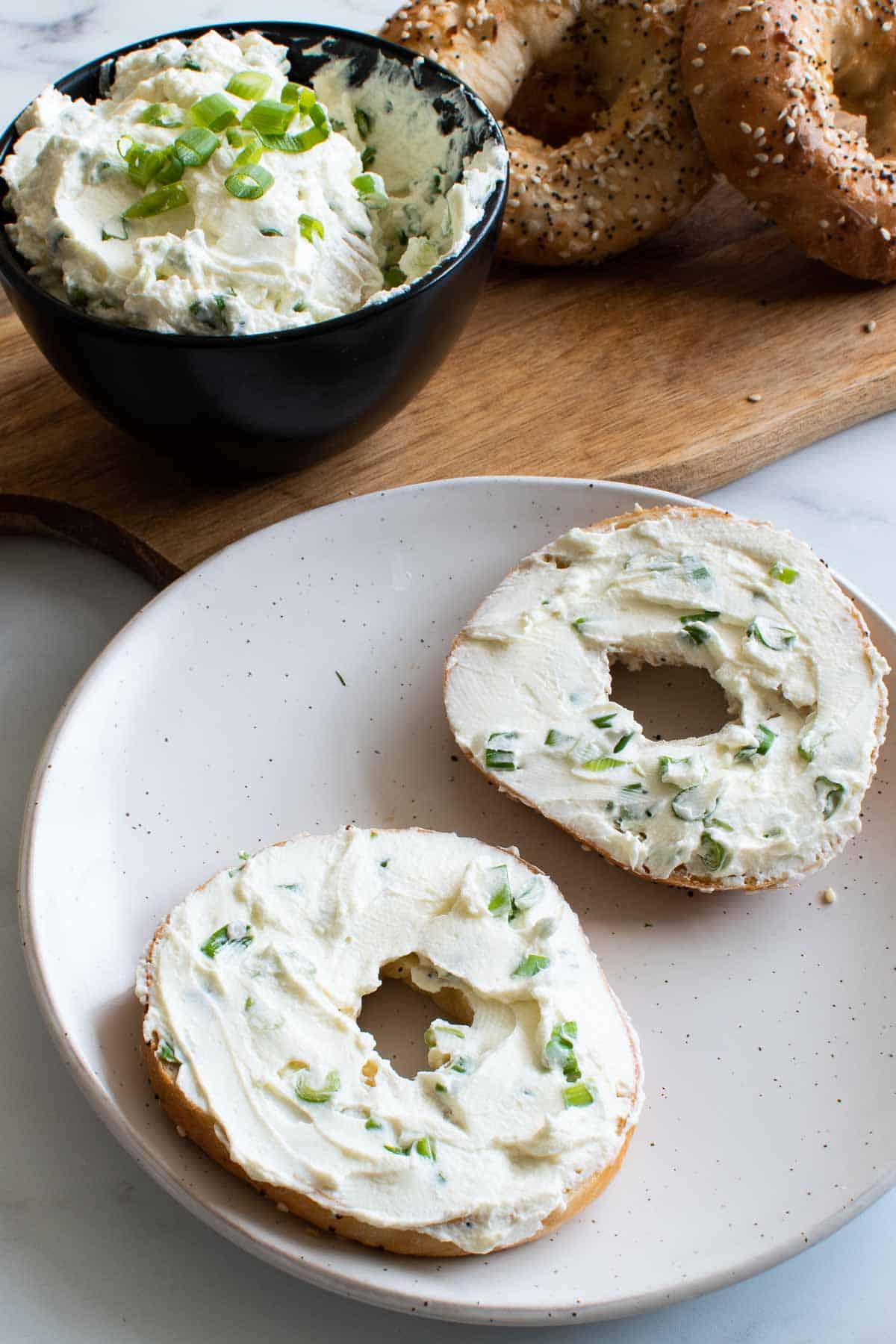 Scallion cream cheese spread on a bagel.