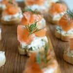 Close up of a smoked salmon canape with cream cheese and dill.