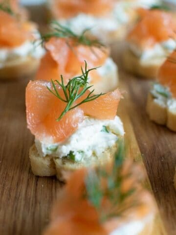 Close up of a smoked salmon canape with cream cheese and dill.