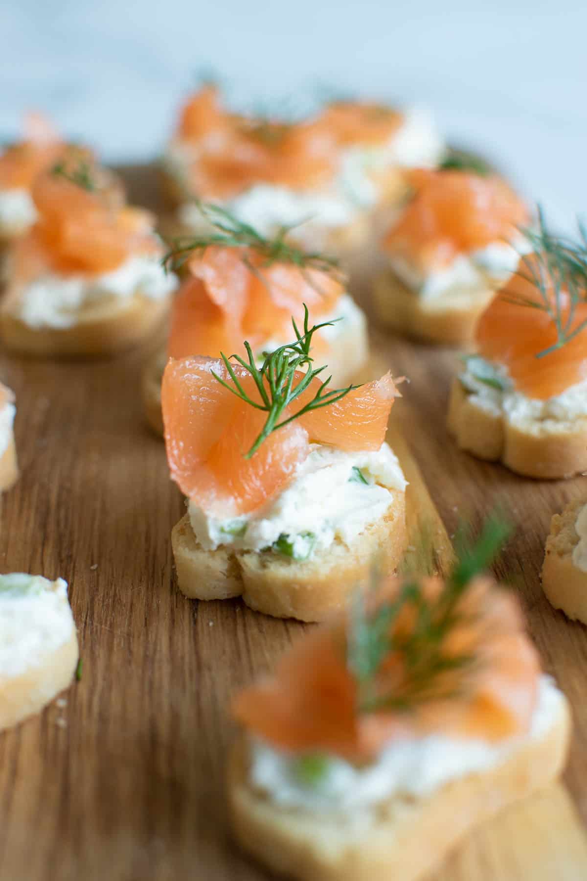 Close up of a smoked salmon, dill and cream cheese blini.