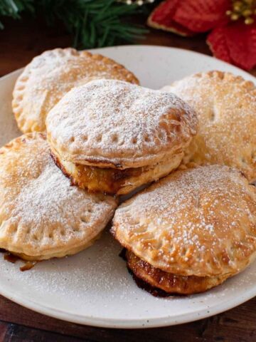 Puff pastry mince pies with icing sugar.