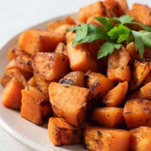 Sauteed sweet potatoes on a plate.