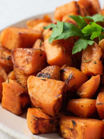 Sauteed sweet potatoes on a plate.