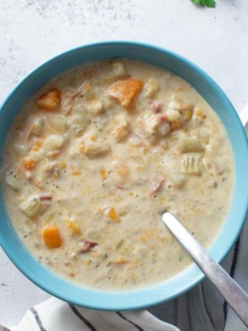 A bowl of ham and potato soup.