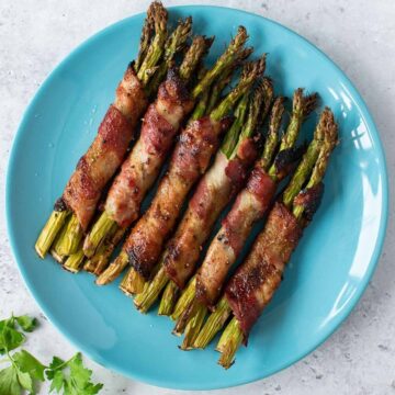 Bacon wrapped asparagus on a plate.