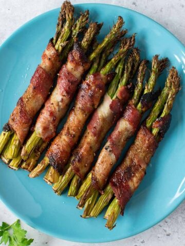 Bacon wrapped asparagus on a plate.