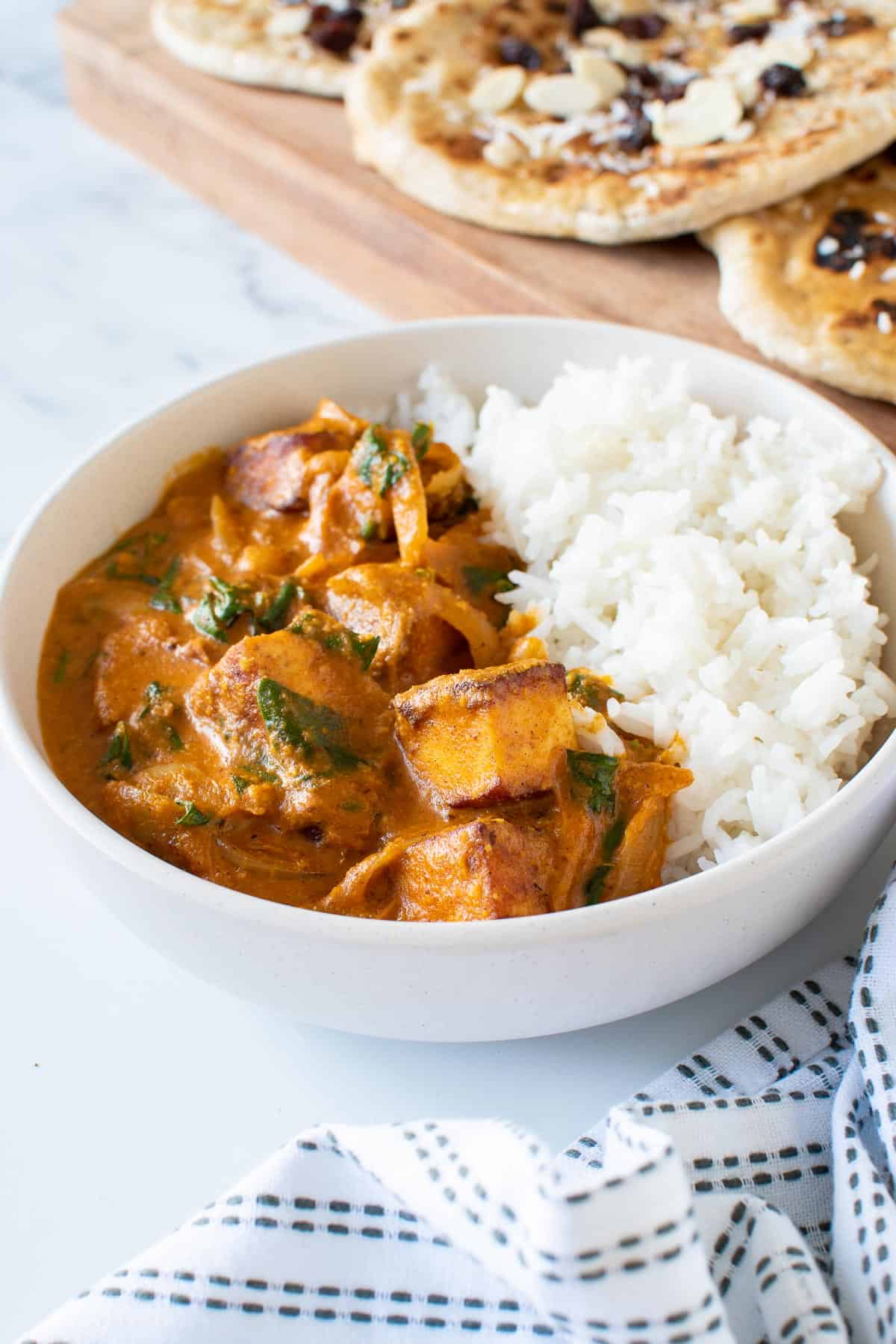 Close up of coconut curry with paneer.