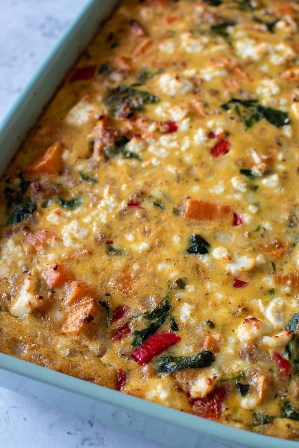 Close up of a casserole with sweet potatoes and sausage.