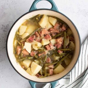 Ham, green beans and potatoes in a pot.