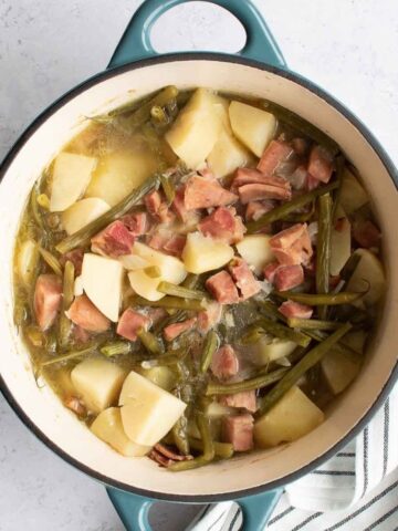 Ham, green beans and potatoes in a pot.