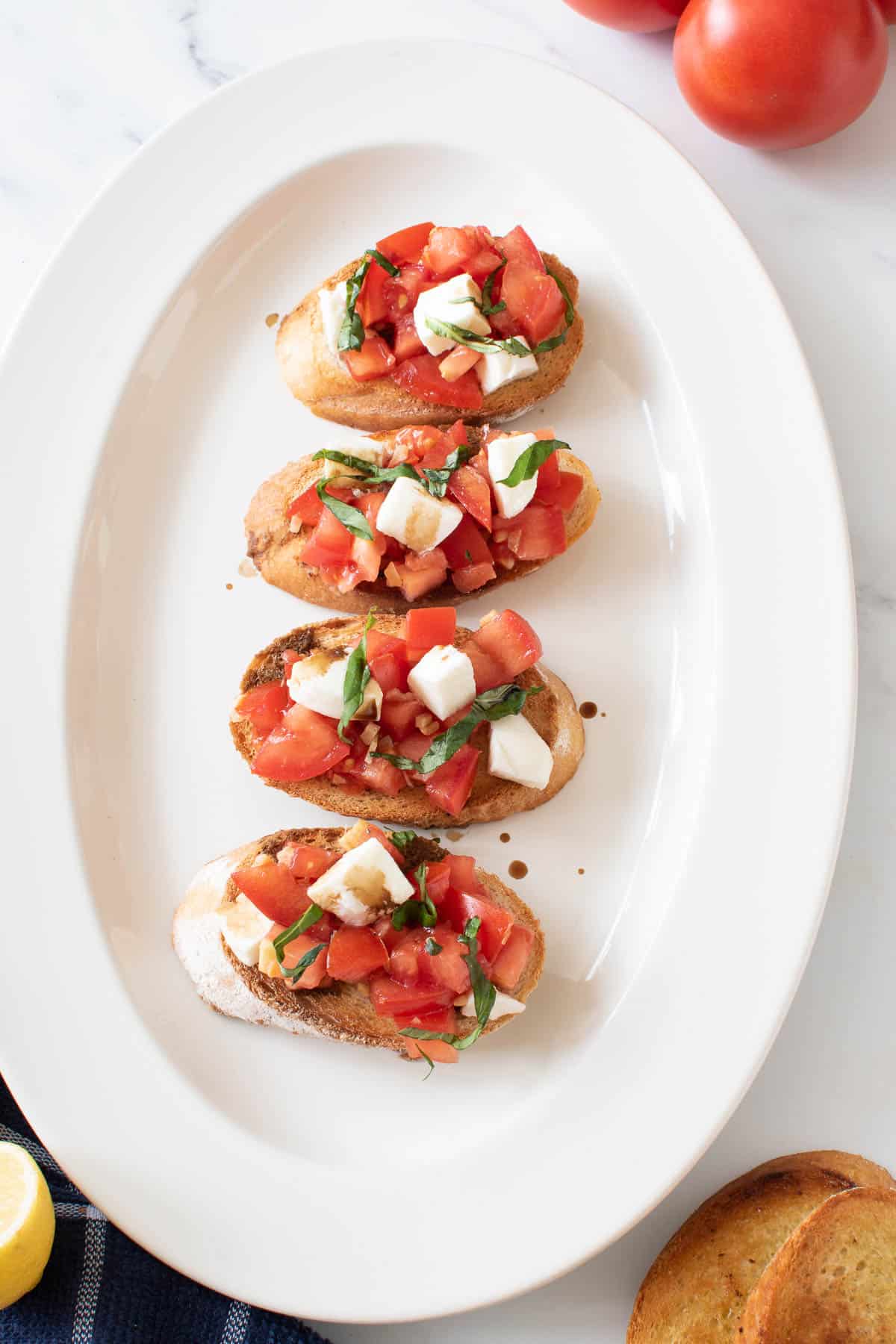 Four slices of plated bruschetta.