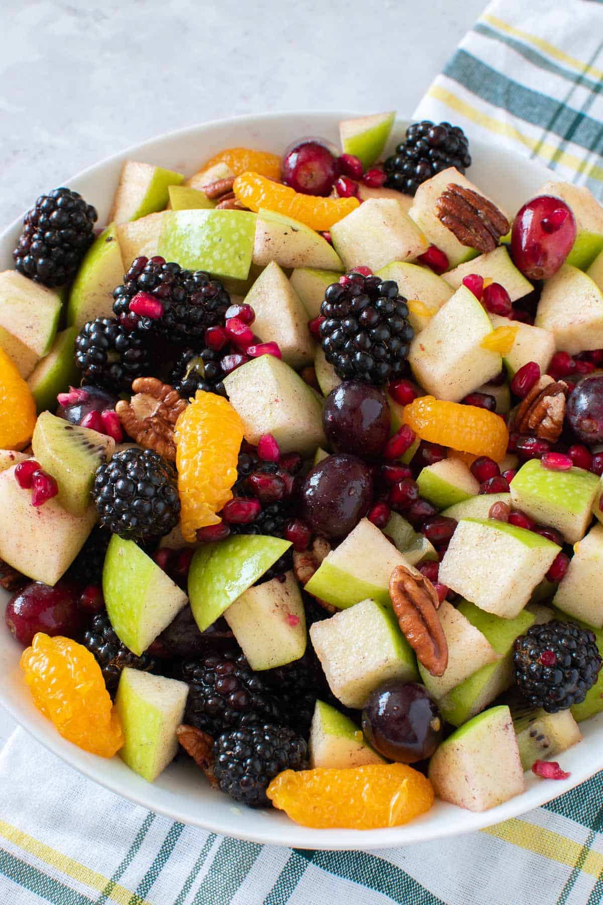 Mixed fruits, nuts and cinnamon salad in a bowl.