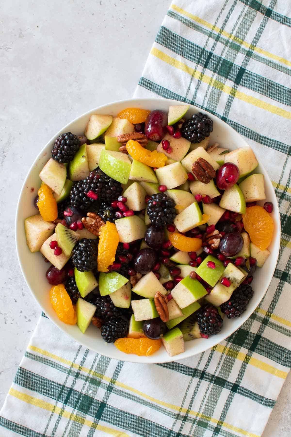 Mixed fruit salad with pecans, apples, berries and pomegranate.