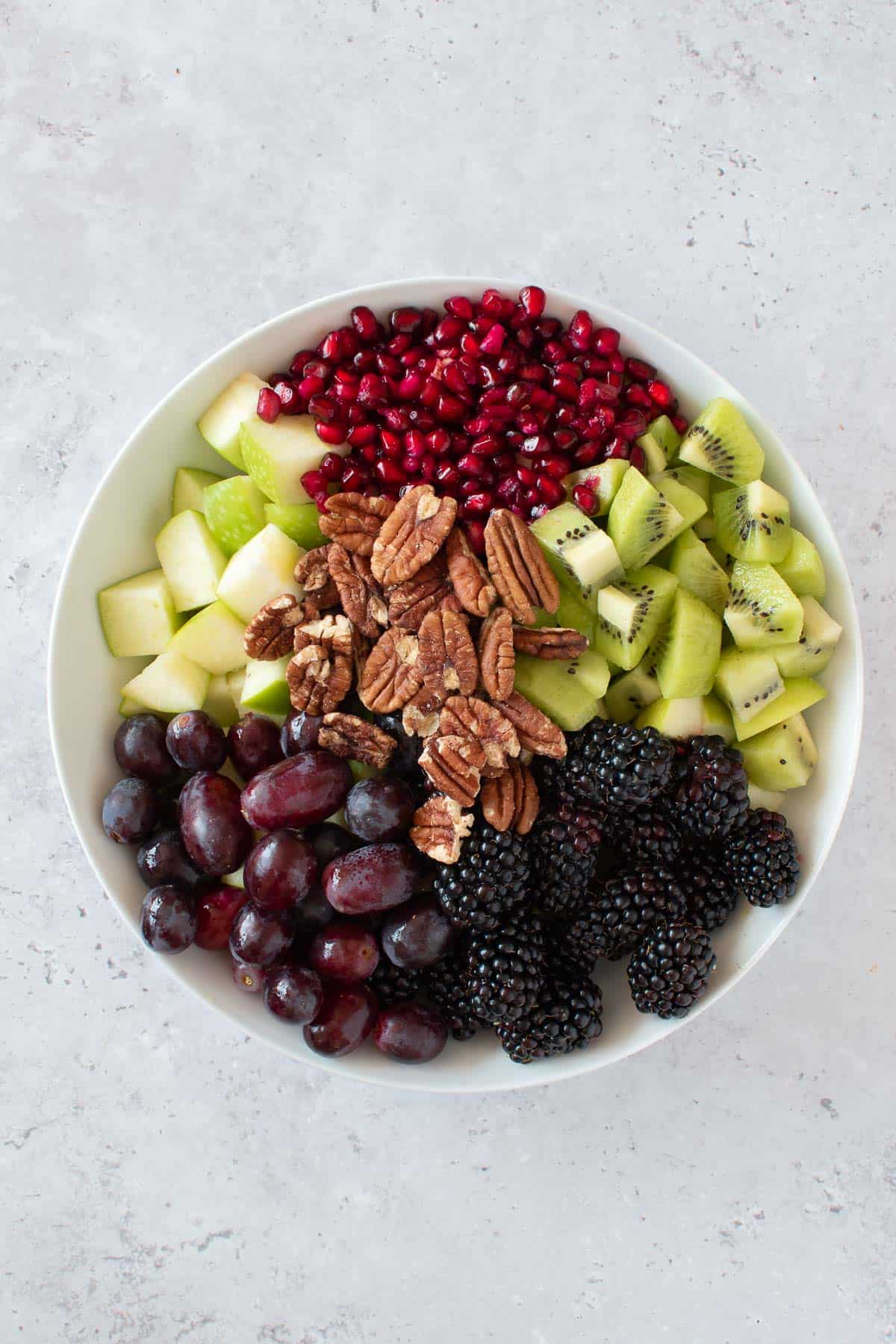 Pecans, pomegranate, kiwi, apple, grapes and blackberry salad.