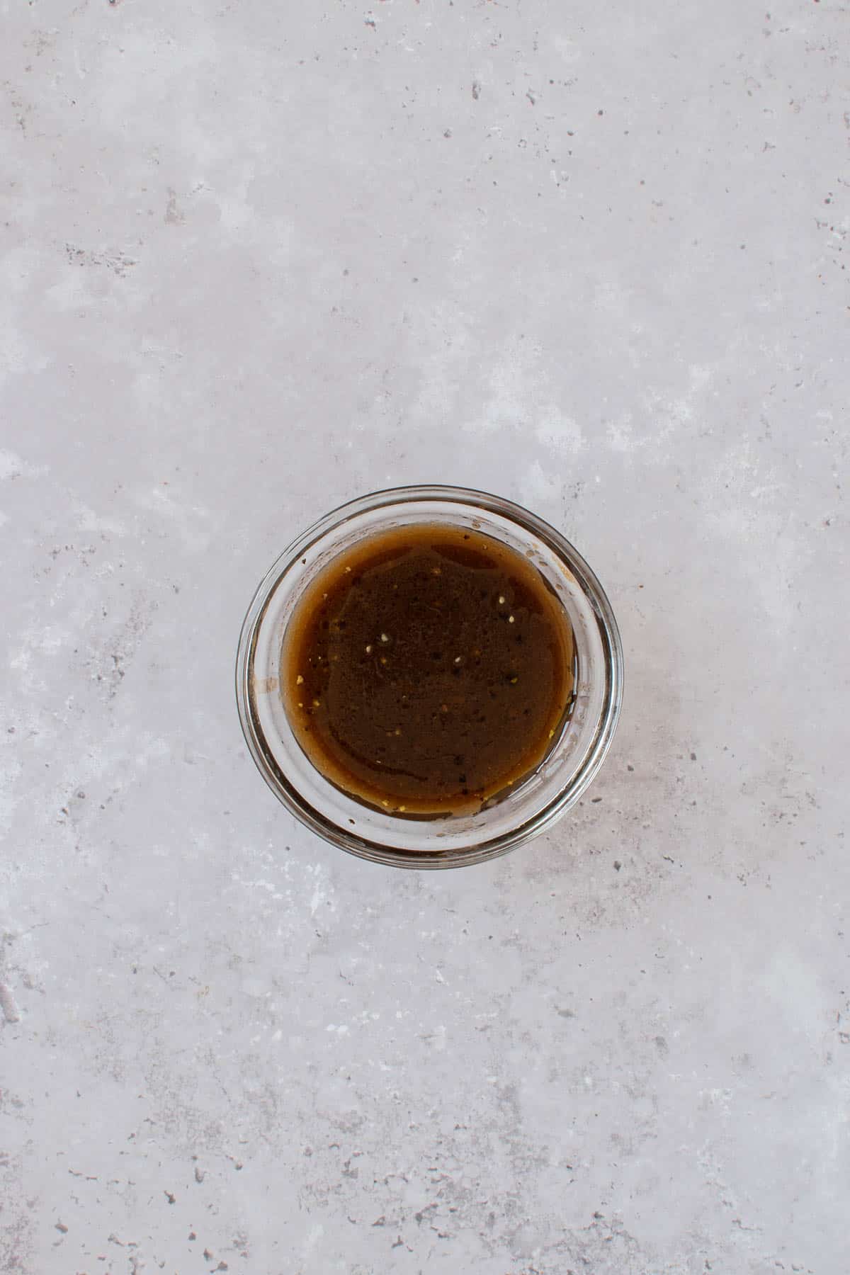 Balsamic vinaigrette dressing in a small bowl.