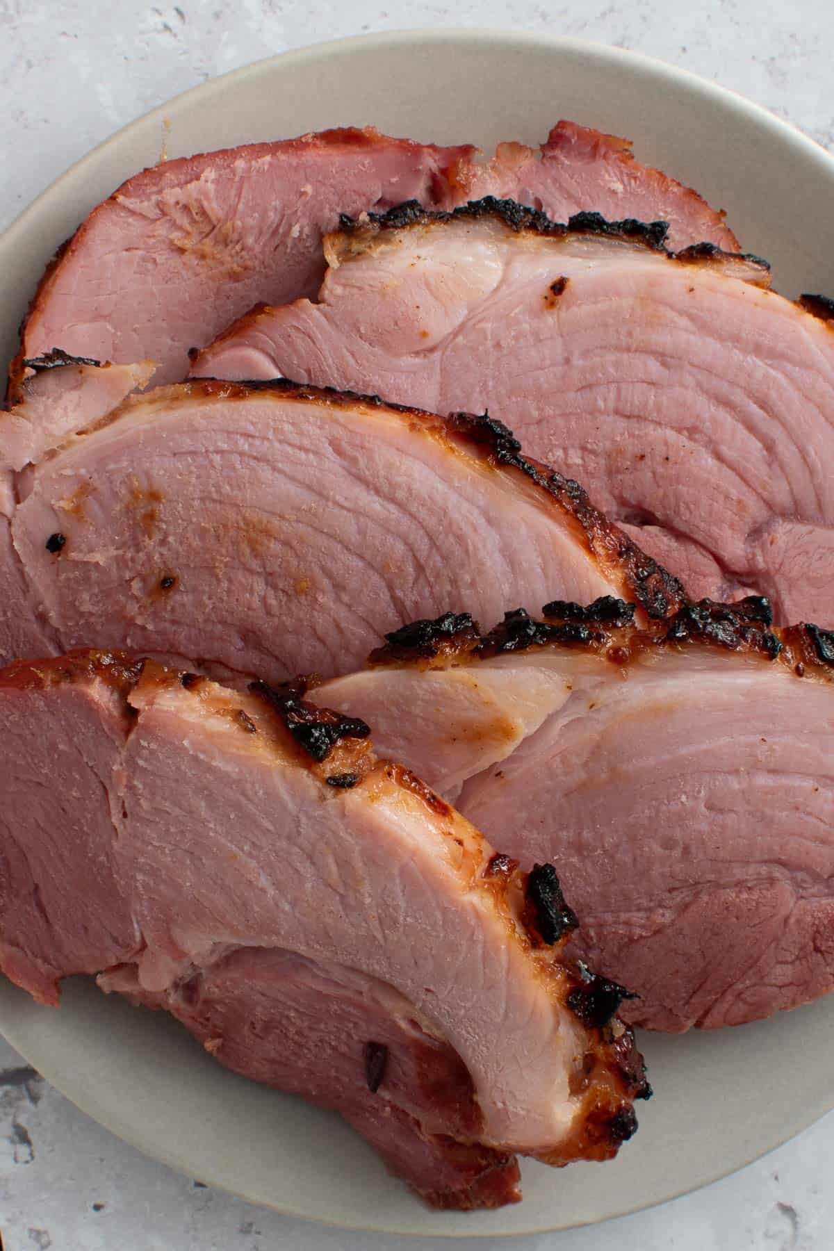 Sliced air fried gammon on a plate.
