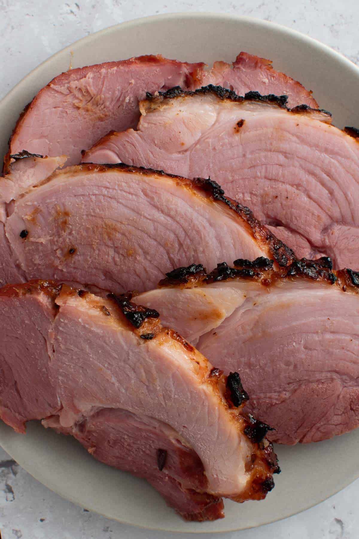 Sliced air fried gammon on a plate.