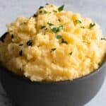 Swede mash in a bowl, garnished with parsley.