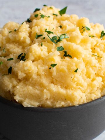 Swede mash in a bowl, garnished with parsley.