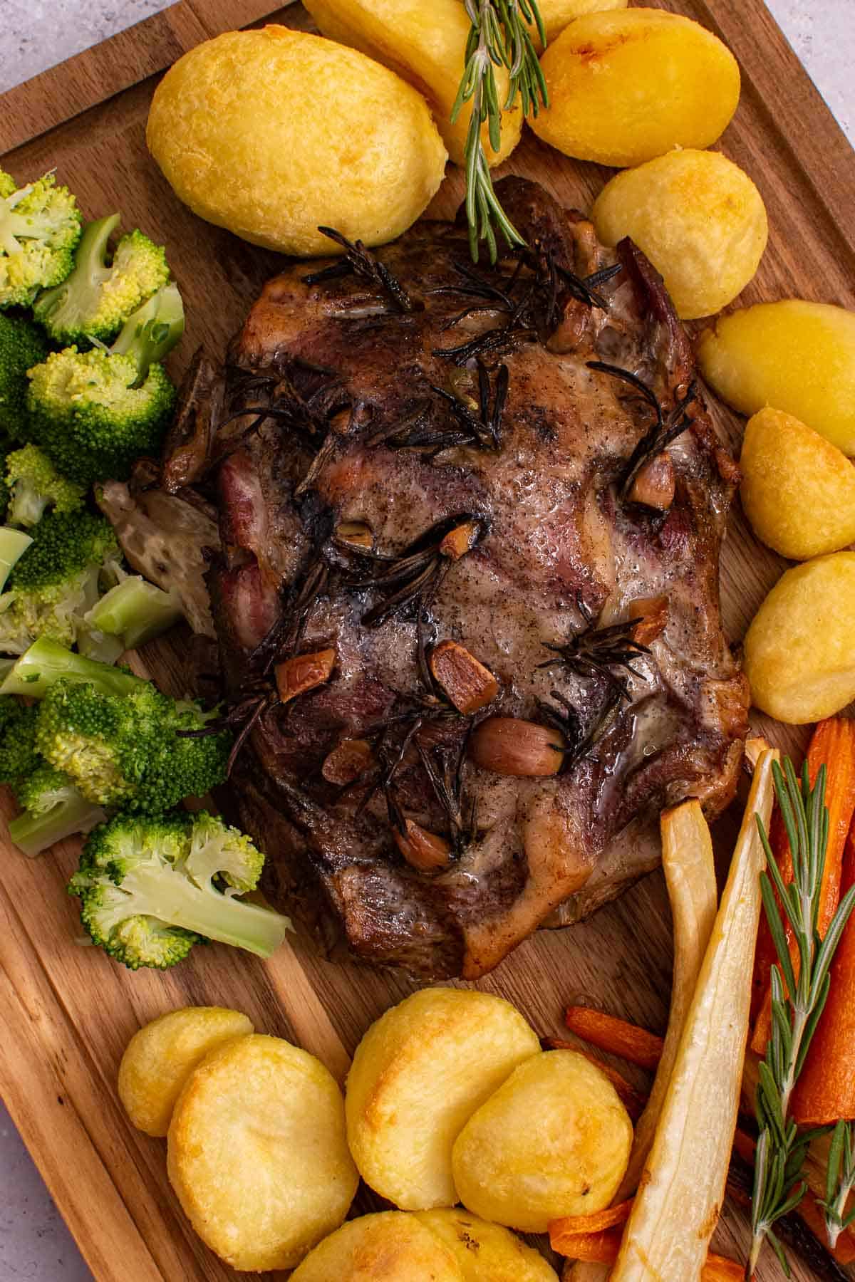 Slow cooked lamb surrounded by vegetables.